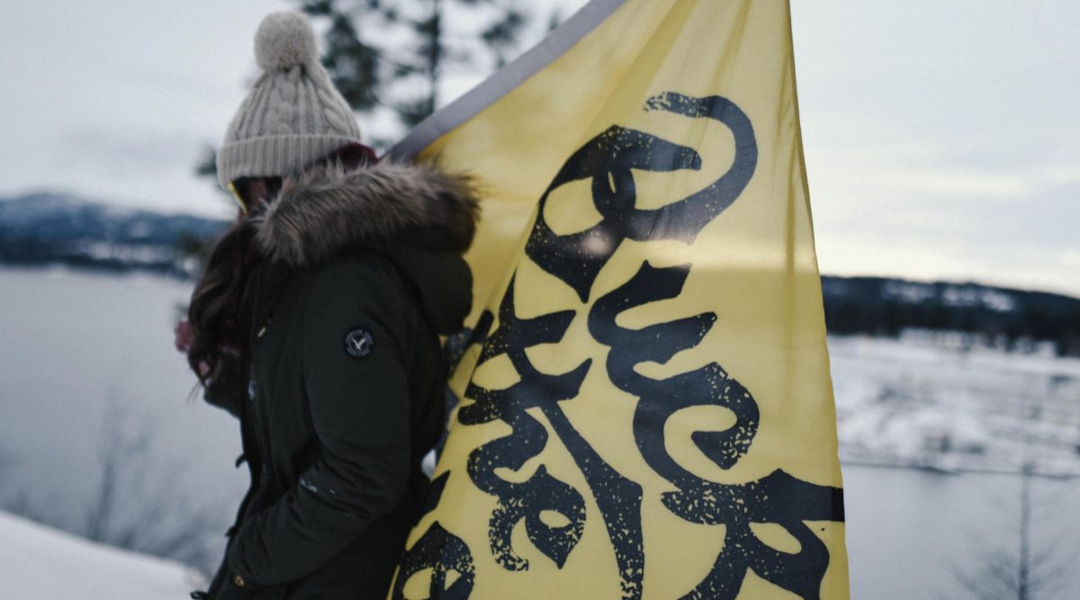 Woman carrying yellow Buck the Quo flag