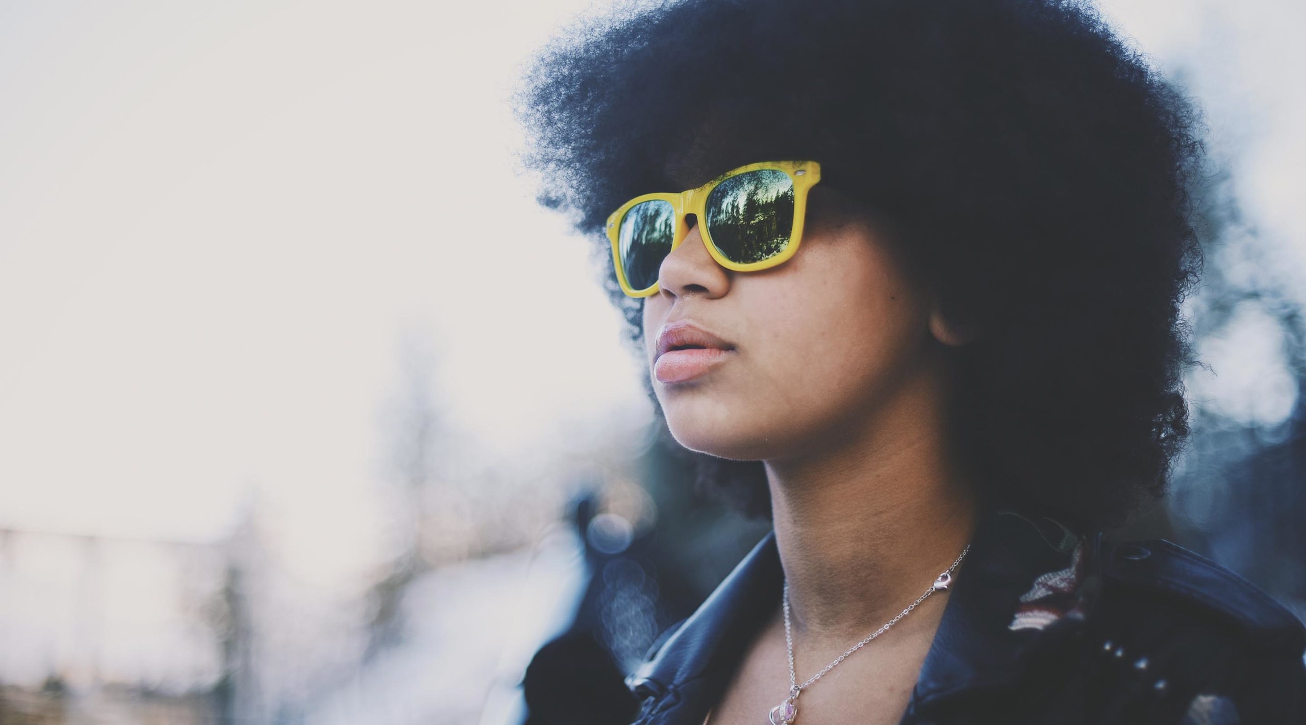 Teen girl wearing yellow sunglasses