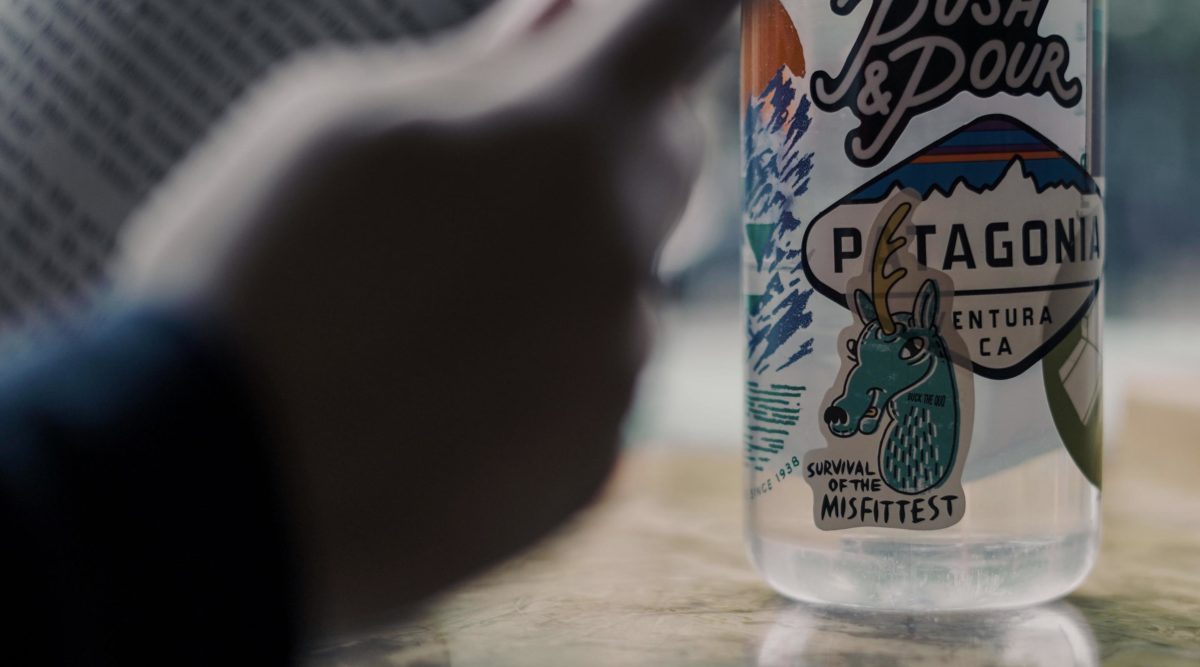 Water bottle with buck unicorn sticker that reads Survival of the Misfittest