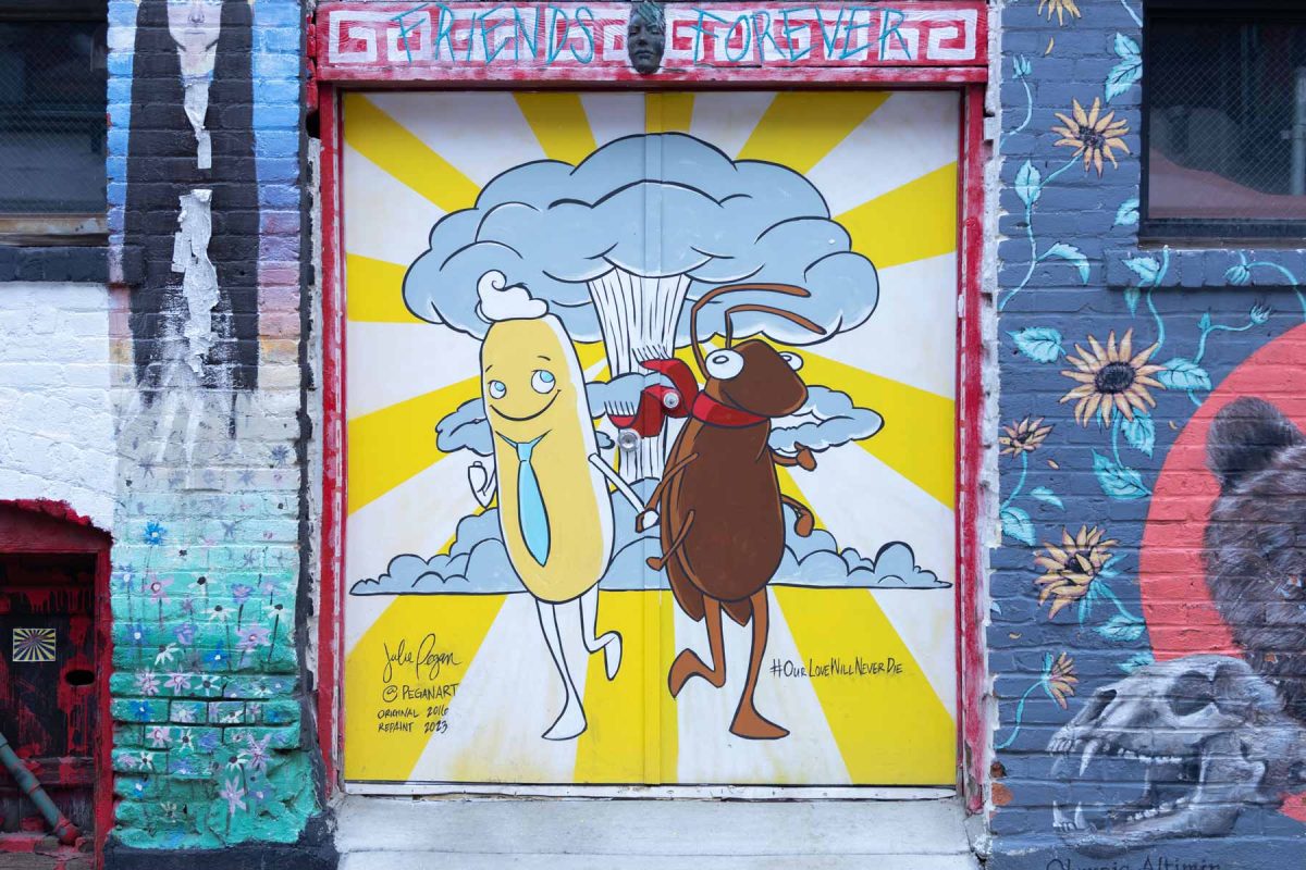 Mural showing a Twinkie and a cockroach holding hands with a mushroom cloud in the background